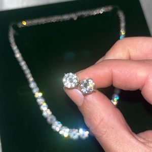 Rhodium plated earrings and necklace set, in original box, zircon stones.